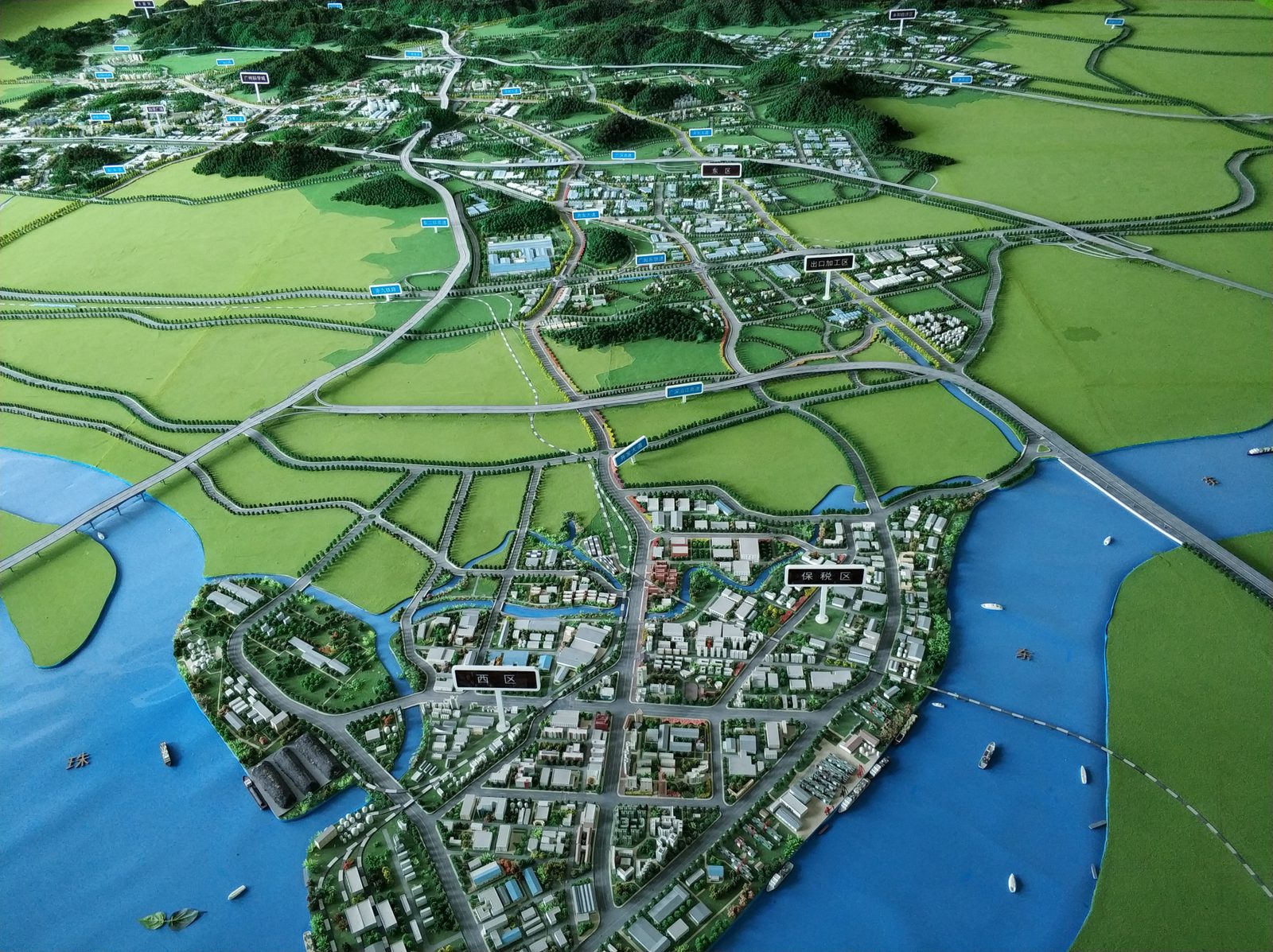 Regional planning model showing districts, highway interchanges and a river frontage