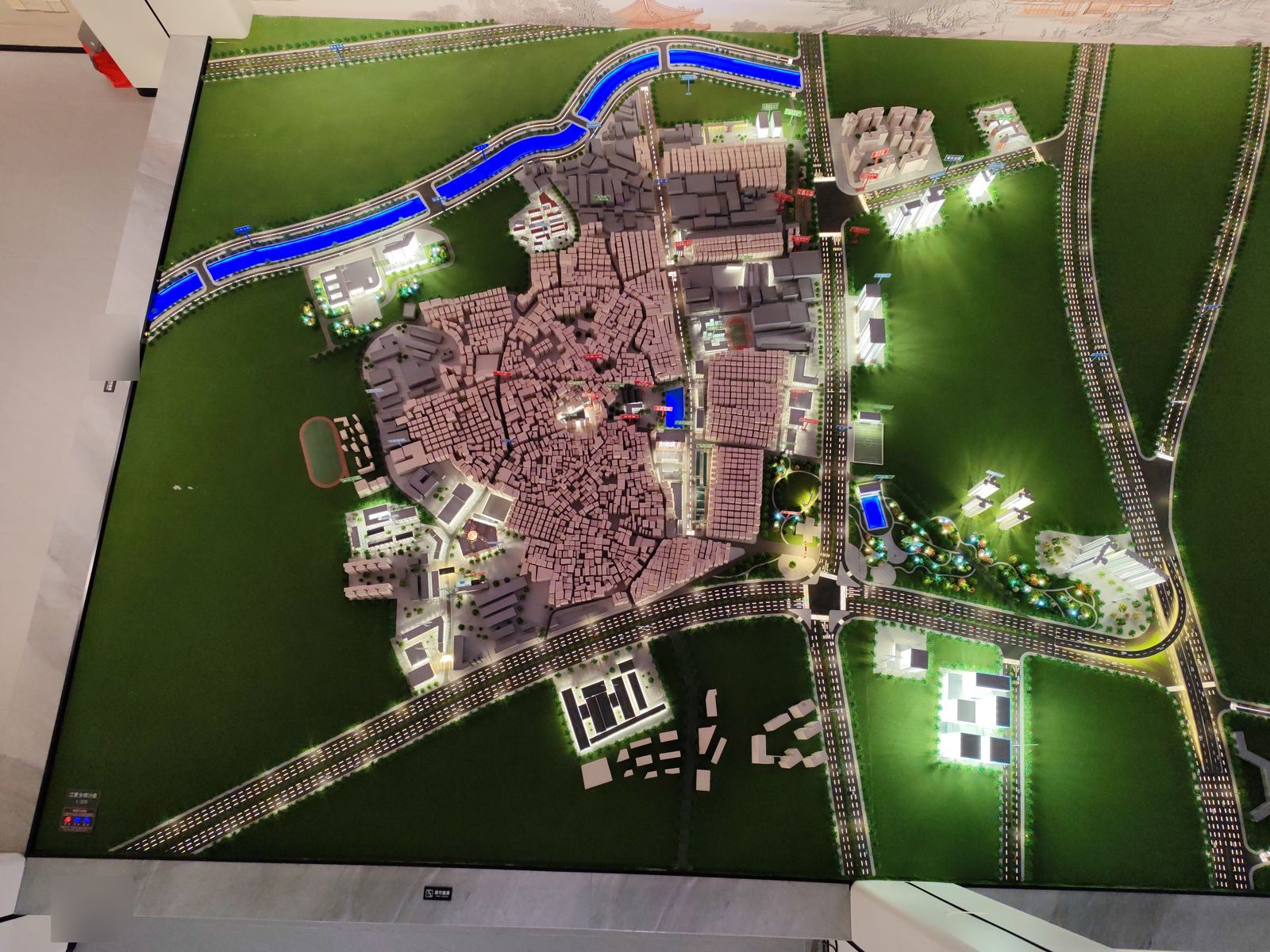 Overhead view of an urban regeneration master plan model with road network and dense historic blocks